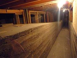 A walkway beneath the auditorium floor, from the northeast basement room to the stage.